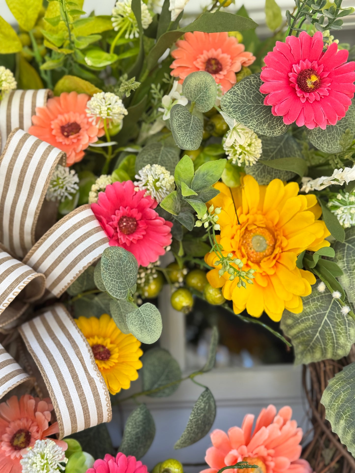 Vibrant Floral Wreath with Striped Bow