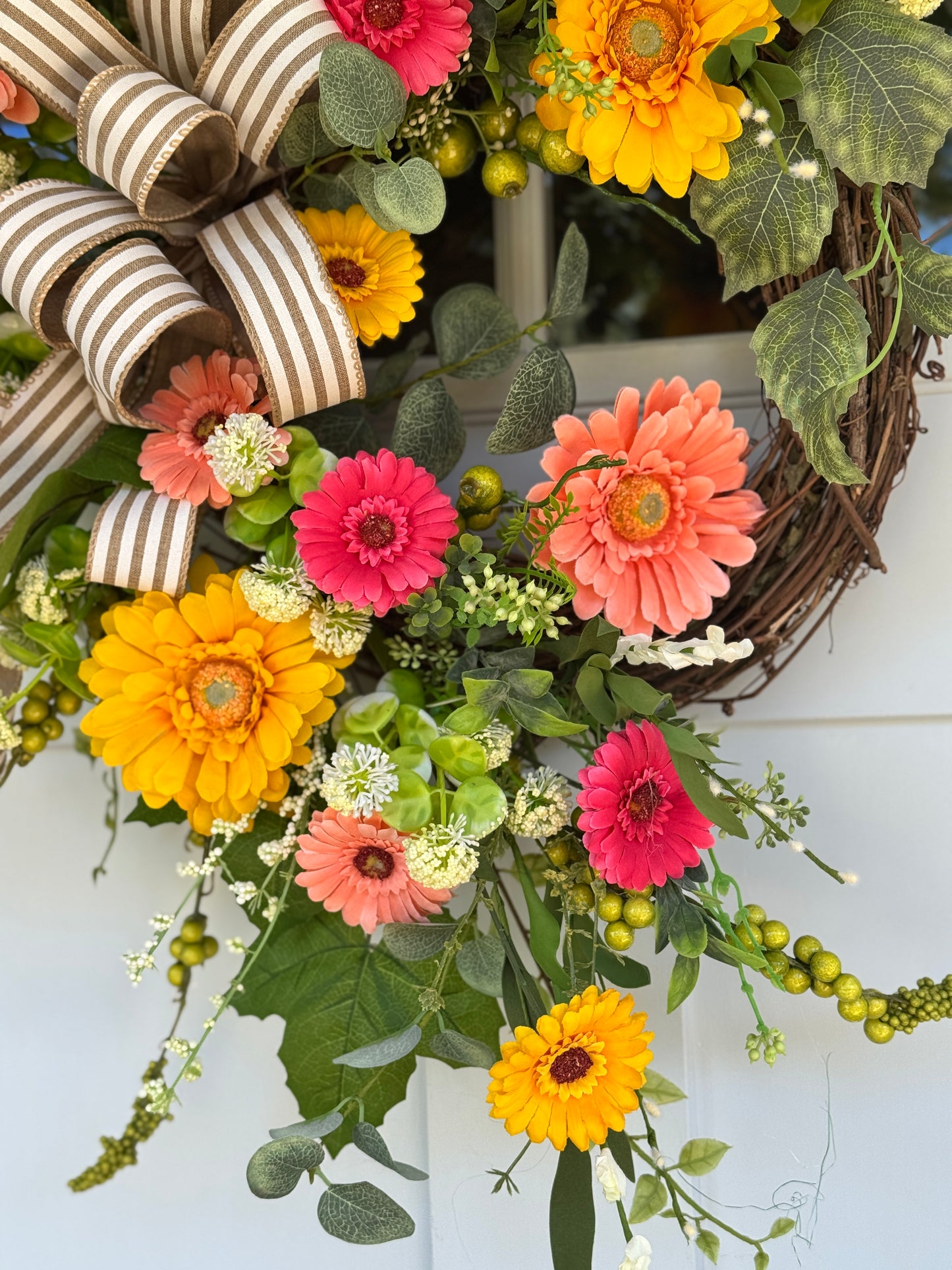Vibrant Floral Wreath with Striped Bow